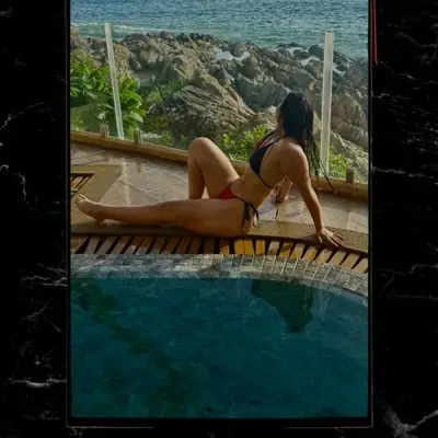 Yuvibaby by a pool overlooking the ocean.